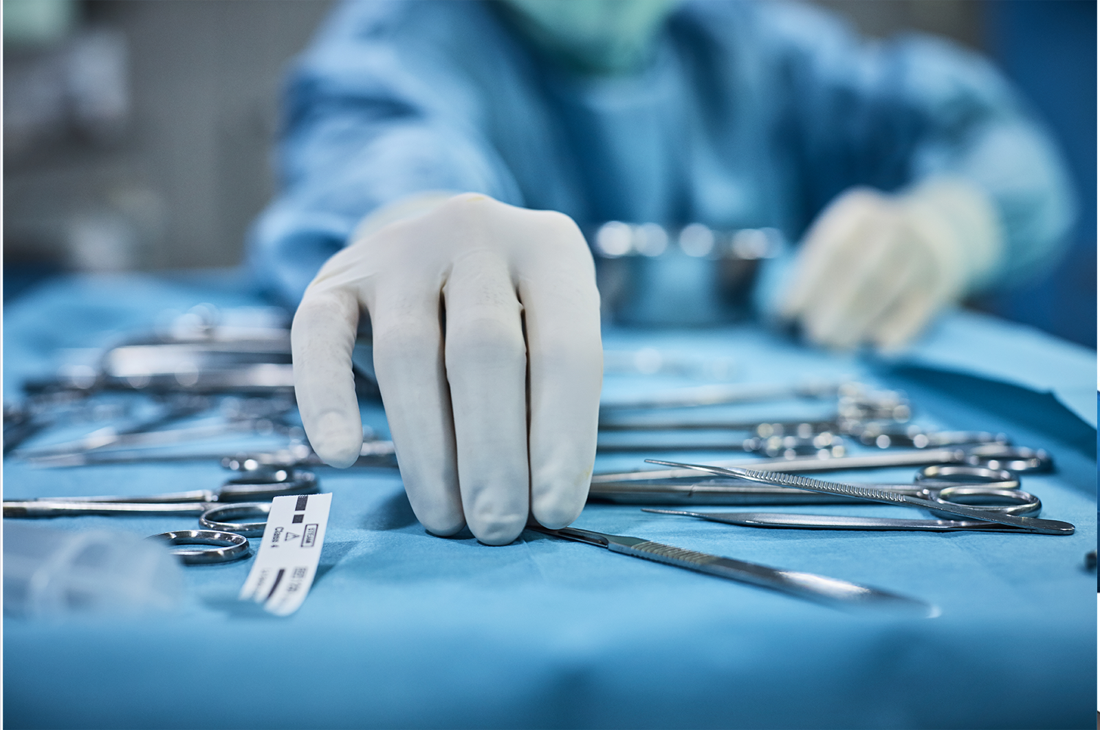 Picture of Latex gloves picking up forceps